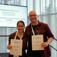 photo of Eric and Isil receiving award